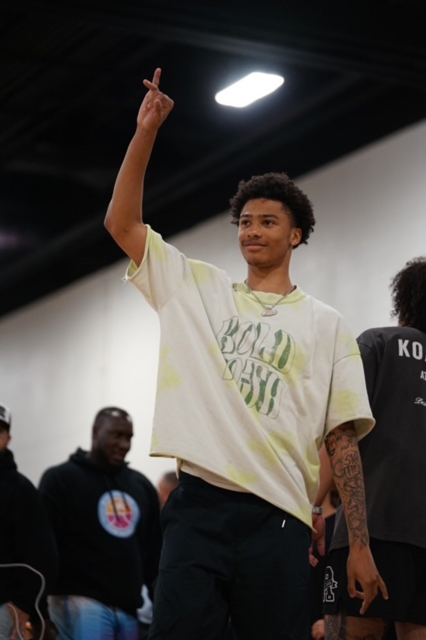 An athlete pointing to the rafters after the game