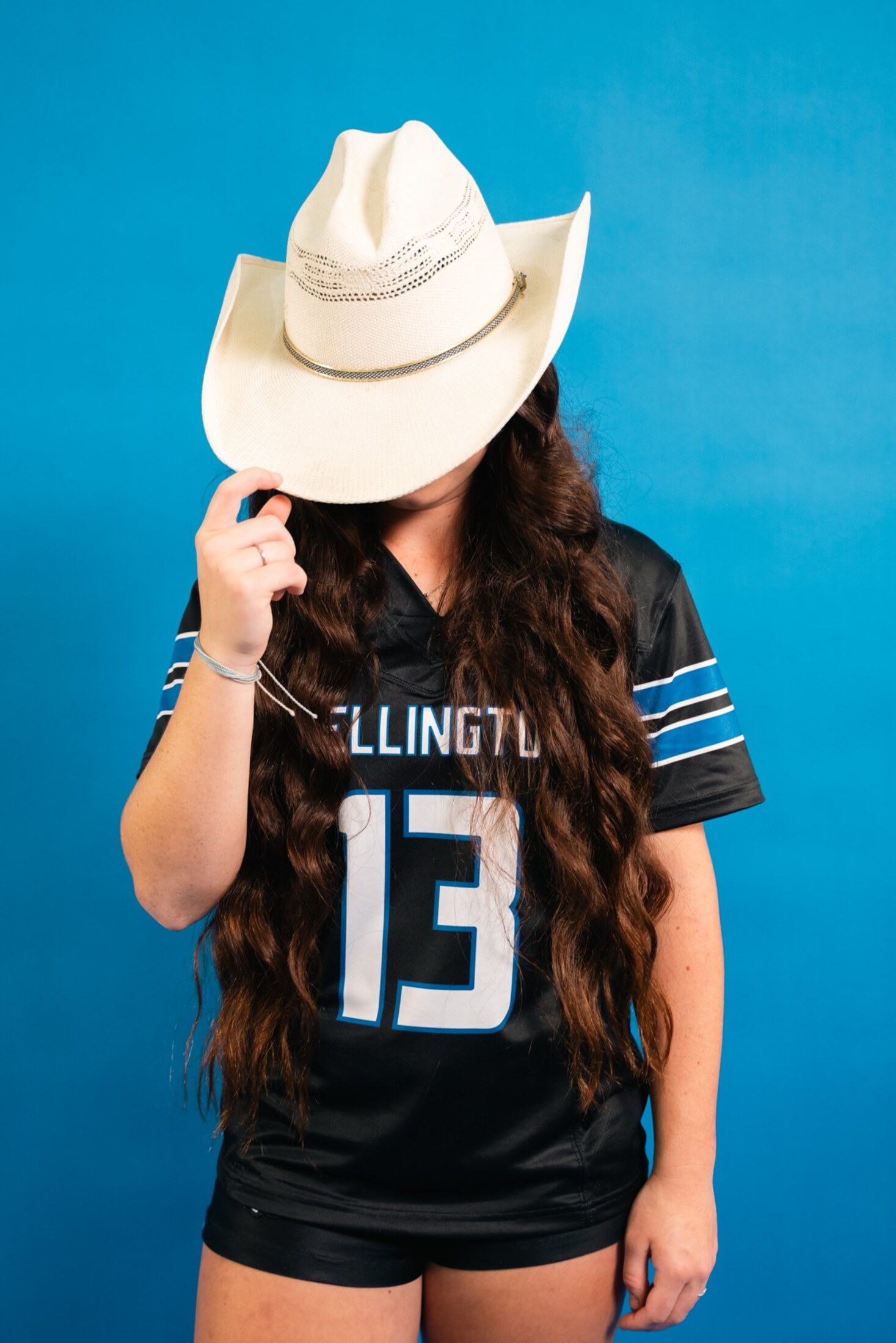 Media day portrait with a white cowboy hat