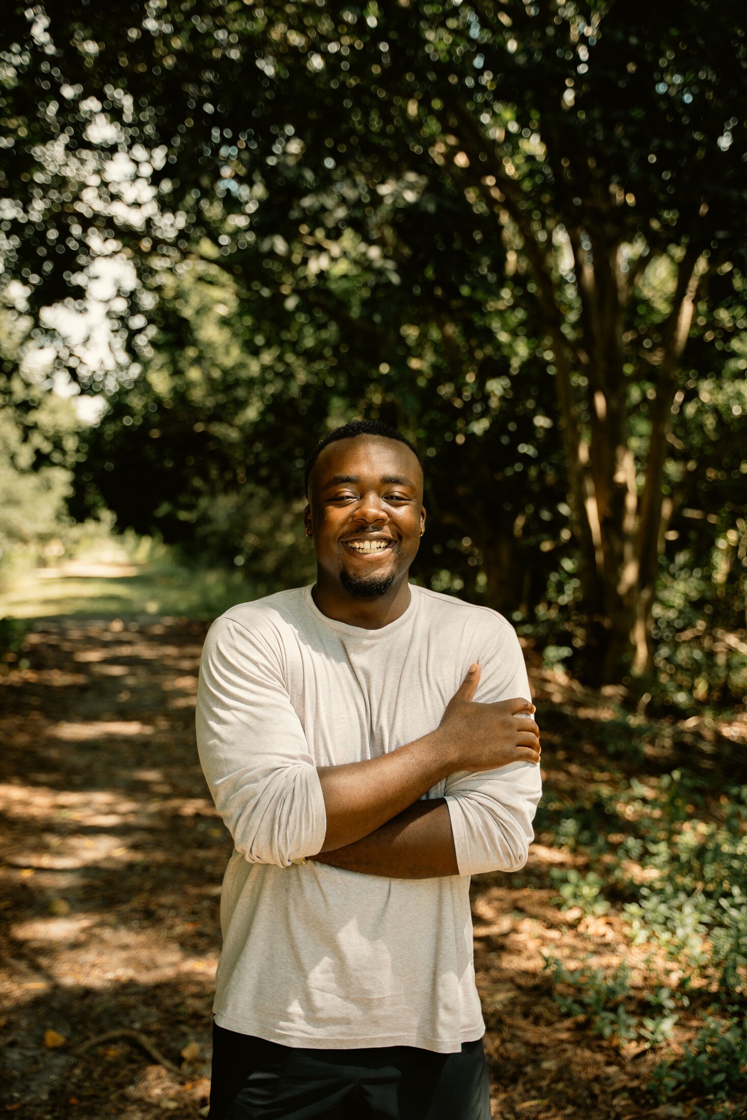 Portrait in the trees, arms crossed