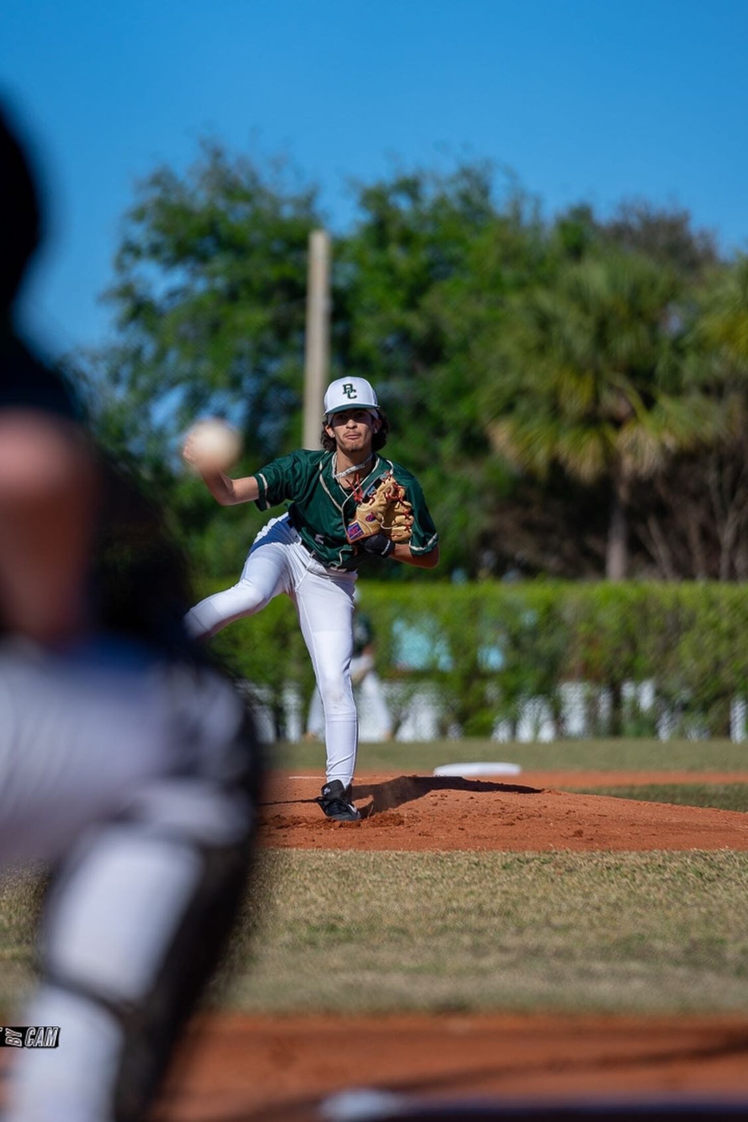 Baseball pitcher mid-delivery on the mound
