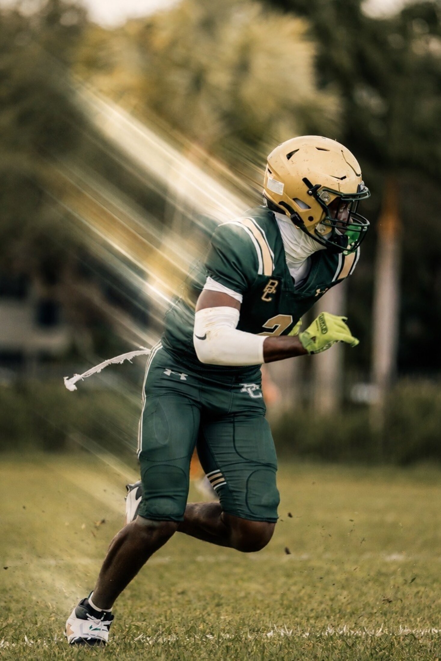 Football player sprinting through the sun flare