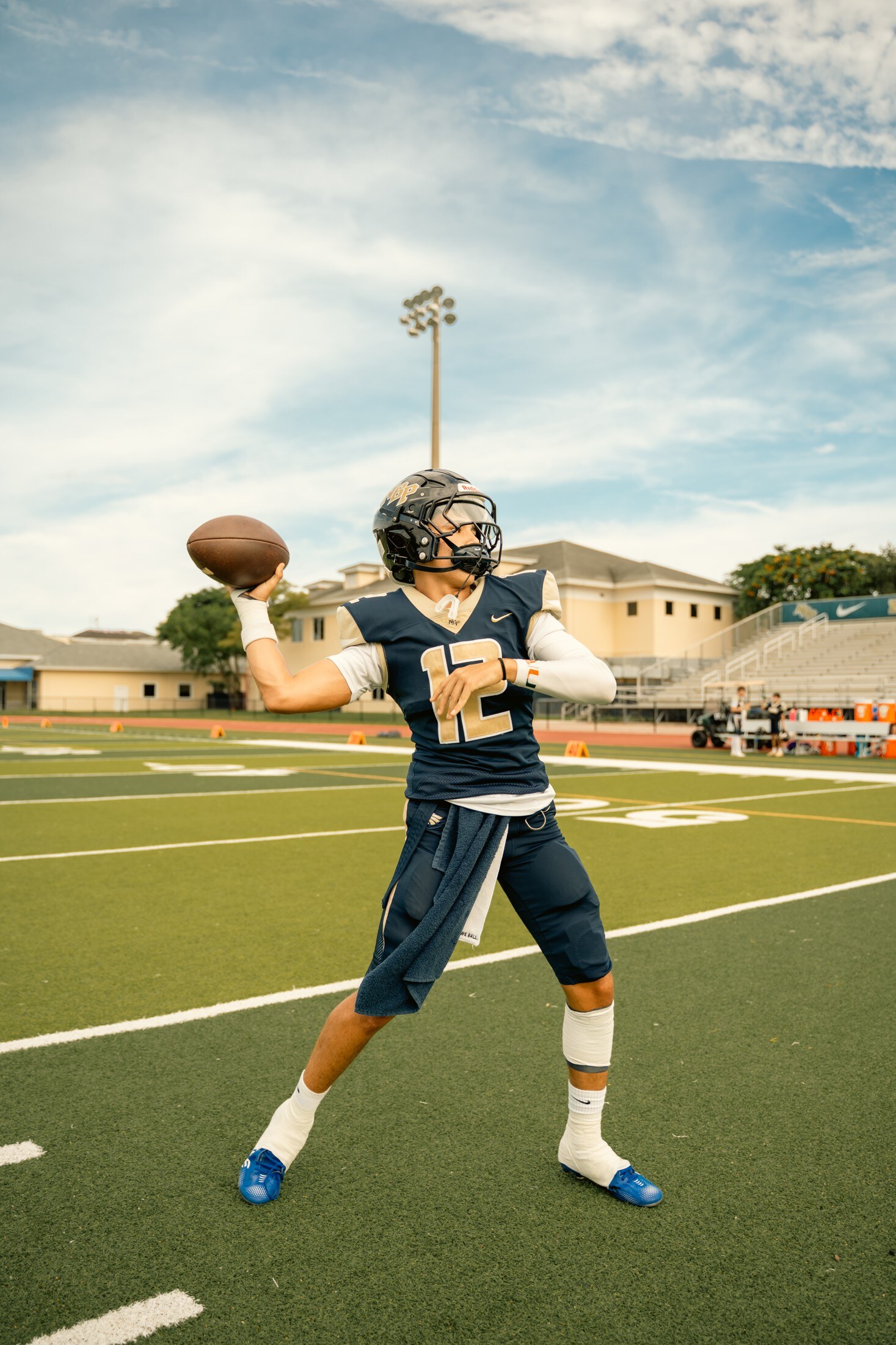 Quarterback throwing on a bright afternoon