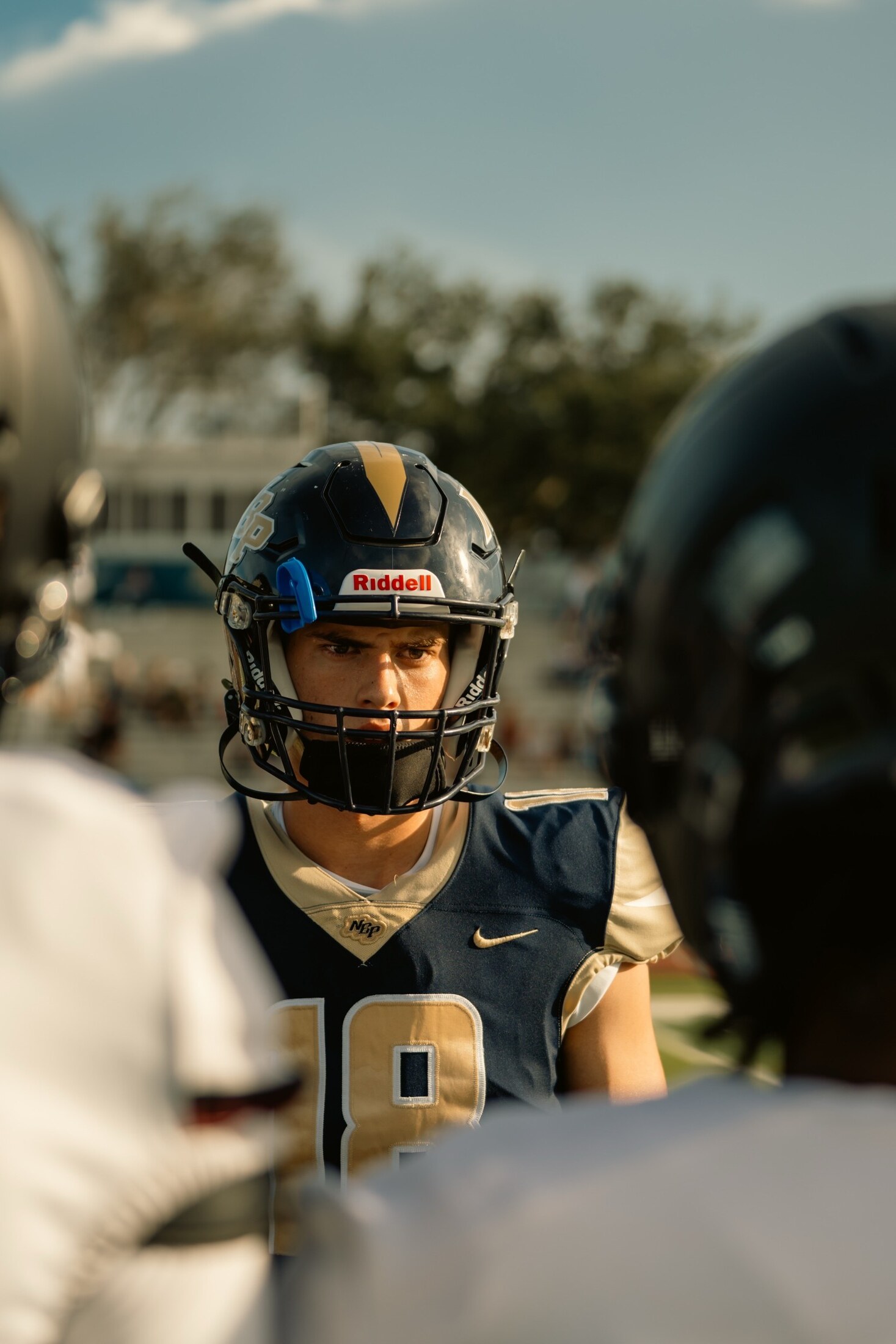 Football player in the huddle between plays