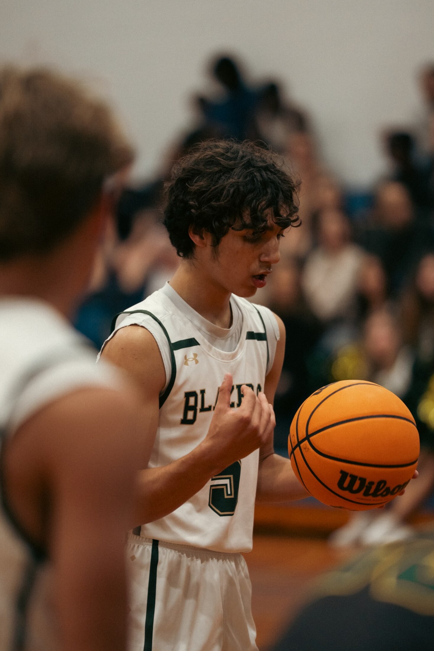 Basketball player holding the ball at the sideline