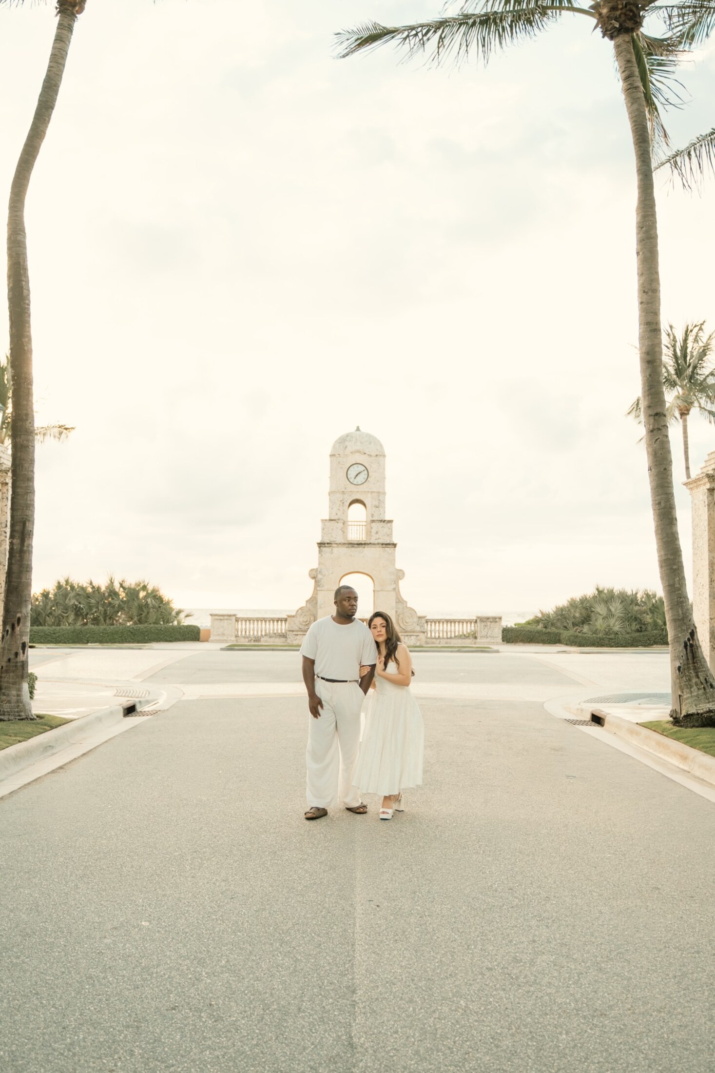 Bride walking down a palm-lined road