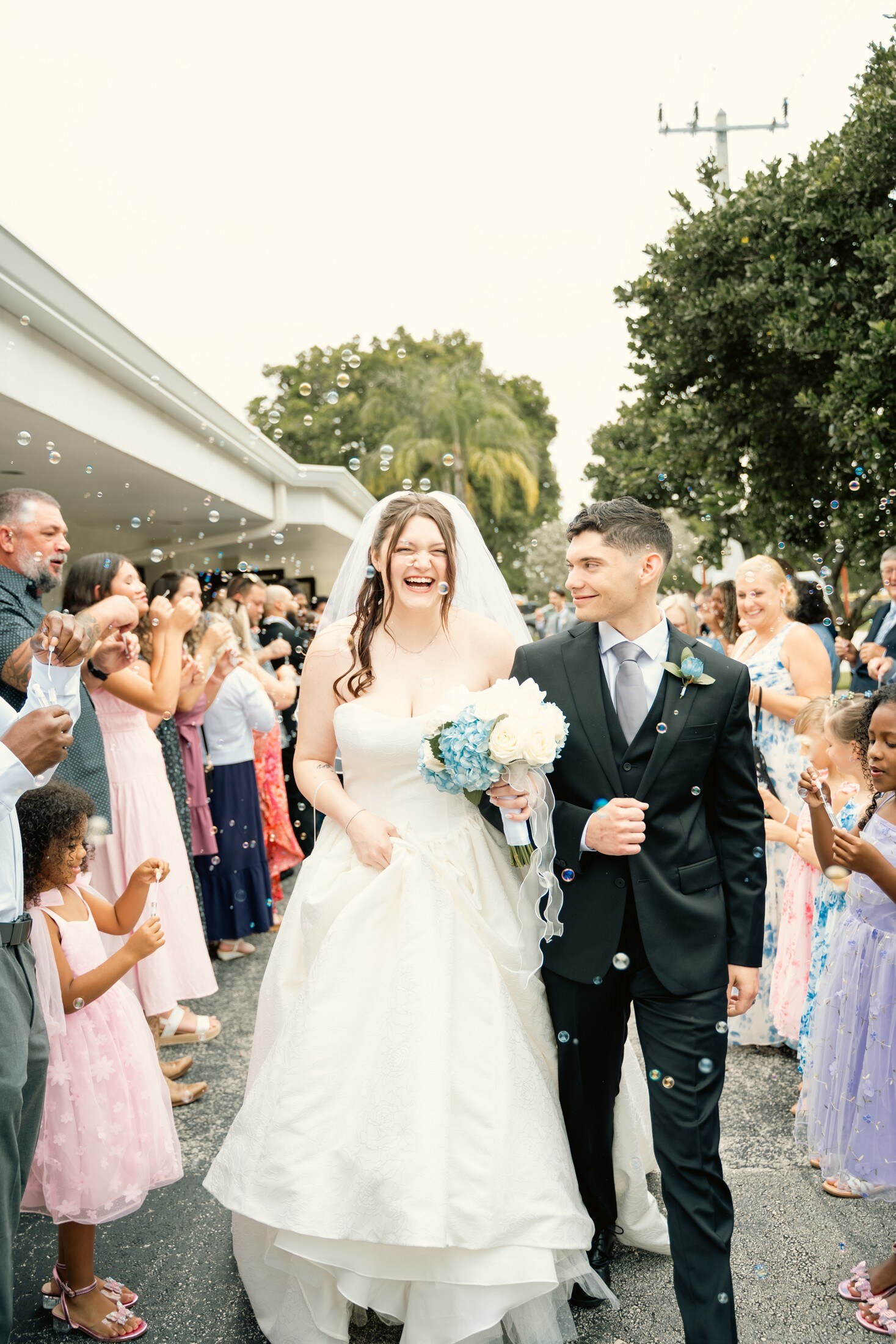 Bride and groom walking back down the aisle as guests celebrate